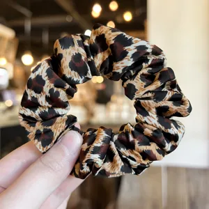 Classic leopard print hair scrunchie for women, soft fabric elastic hair tie for daily wear.
