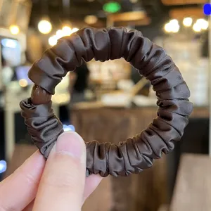 Elegant brown satin scrunchie for women, high elasticity hair tie, chic ponytail hair accessory.