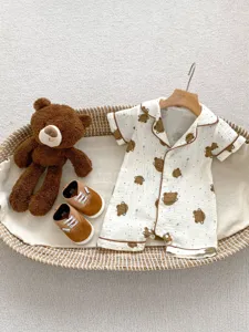 Detailed view of baby short-sleeve cotton romper featuring adorable bear print in summer style.