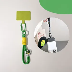 Detail view of ins style green short phone lanyard wrist strap with metal carabiner and tether.