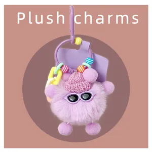 Gros plan détaillé du charm en peluche mignon avec bonnet tricoté, lunettes et perles.