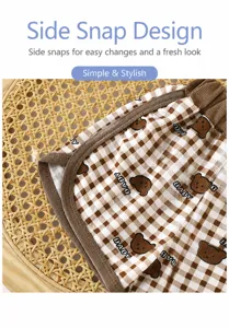 Children summer shorts detail, brown check pattern with cute bear print, soft and breathable fabric.