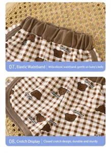 Baby shorts detail close-up showing elastic waistband and closed crotch design, plaid bear print.