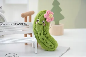 Cute fuzzy pickle plush keychain with pink flower, soft vegetable bag charm pendant.