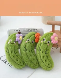 Cute plush pickle keychain with flowers, soft stuffed vegetable pendant for bag charm.