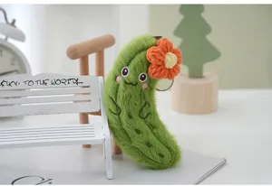 Cute plush cucumber keychain detail, soft green vegetable toy with orange flower charm.