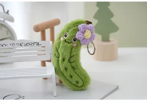 Cute plush cucumber keychain with purple flower, soft stuffed vegetable bag charm.