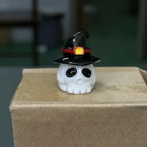 Detailed view of the Halloween miniature resin skull figurine with a witch hat, decor.