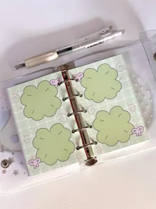 Cute green clover pattern M5 planner inner pages detail shot, aesthetic stationery design.