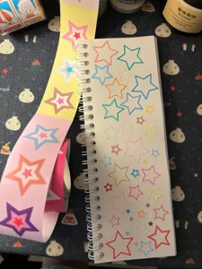 Colorful star sticker roll set with spiral notebook, perfect for planners and craft decoration.