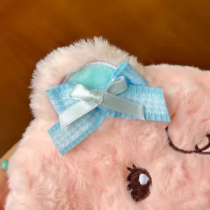 Plush bear pencil case detail view featuring soft pink fabric and cute blue ribbon bow.