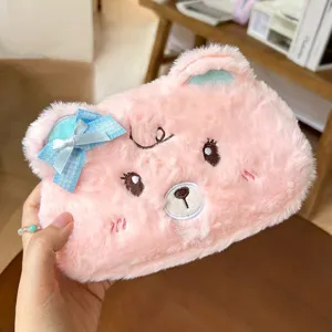 Cute pink plush bear pencil case detail view, soft furry texture with a sweet blue bow.