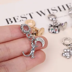 Close-up of a silver alloy cat and moon charm, delicate details for DIY jewelry bracelets.
