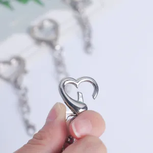 Close-up of a silver heart-shaped lobster clasp keychain, perfect for DIY bag charms.