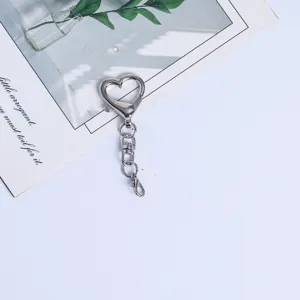 Simple heart shape keychain detail shot, silver metal four section bag hanging chain accessory.