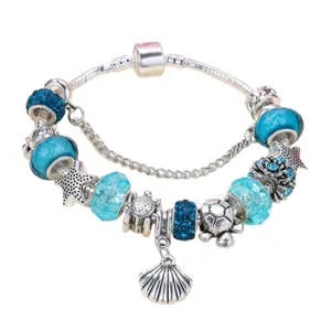 Ocean style blue crystal charm bracelet with turtles, starfish and seashell pendant.