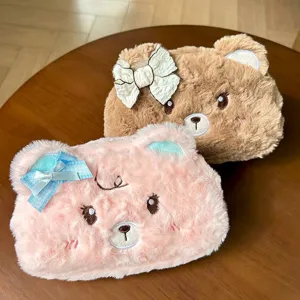 Cute plush bear pencil case with bow detail, soft fuzzy stationery storage bag for students.