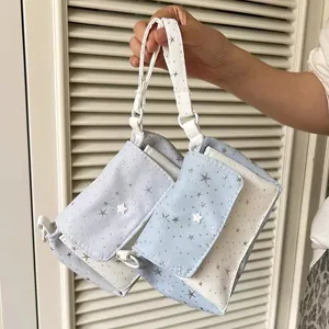 Detail view of cute star pattern multi-layer storage handbag and cosmetic pouch in blue and white.