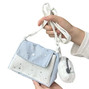 Detailed view of the cute star patterned crossbody bag with adjustable strap and fluffy plush charm.