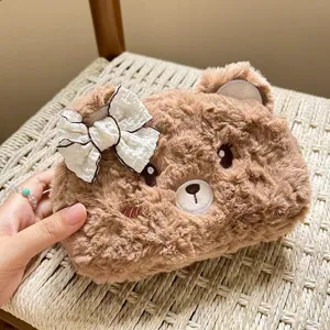 Close-up detail of cute plush bear pencil case showing soft furry texture and sweet bow ribbon.
