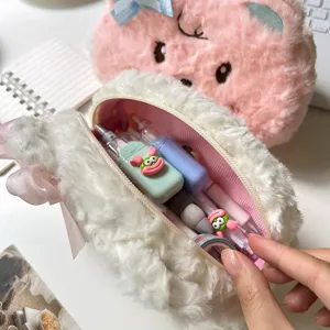 Fluffy white pencil case detail, cute plush stationery organizer with pink lining and bow.