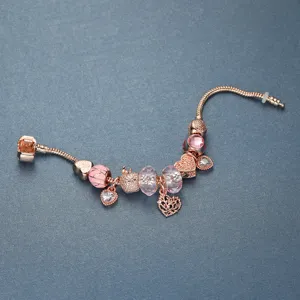 Rose gold tree of life DIY charm bracelet with pink crystal beads and heart design.