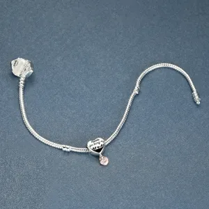 Silver-plated snake chain bracelet detail, heart charm engraved with loving text for mom, clean style.