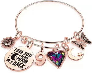 Bracciale rigido estensibile in acciaio inox color oro rosa con girasole e cuore di cristallo.