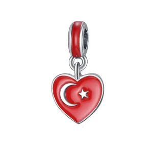Detail shot of red enamel heart flag charm, silver metal pendant for DIY bracelet and necklace.