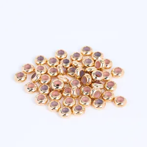 Detail shot of 6-7mm gold silicone stopper beads, perfect for DIY bracelet jewelry making.