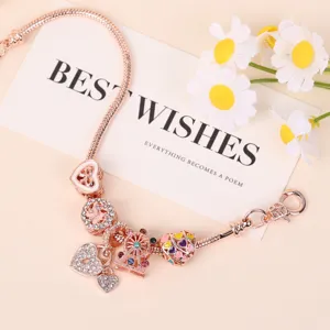 Roségouden DIY bedelarmband met schattige hartjes en reuzenrad bedels voor dames en meisjes.