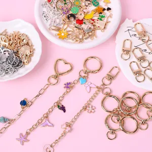 DIY keychain making kit with colorful enamel charms, lobster clasps, and chains for crafting.