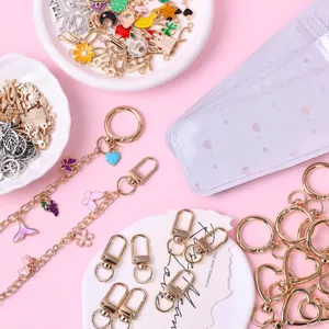 DIY keychain making kit detail showing colorful enamel charms, lobster clasps, and metal chains.