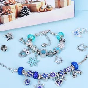 Detailed view of DIY blue charm bracelets with silver beads, snowflakes and crystal elements.