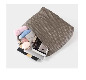 Detailed view of large capacity woven soft leather tote bag showing daily storage interior