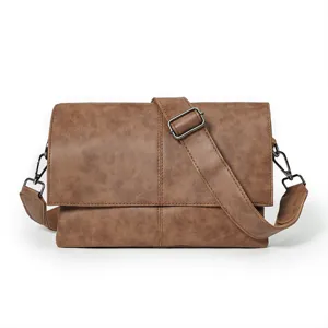 Detail view of brown men's PU leather messenger bag, showing adjustable strap and buckle.