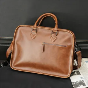 Detailed view of the vintage brown leather briefcase, showing fine stitching and metal zipper.