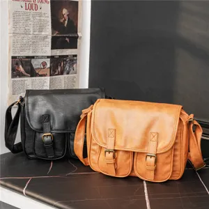 Retro leather messenger bag detail showing texture, dual buckles and casual daily style.