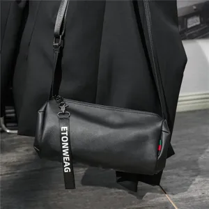 Black cylindrical shoulder bag, stylish casual crossbody bag with strap and metal hardware details.