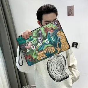 Detailed view of casual printed leather clutch bag with jungle animal pattern and wrist strap.