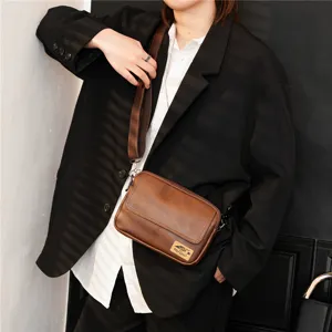 Retro brown leather messenger bag for men and women, stylish vintage cross-body shoulder bag.