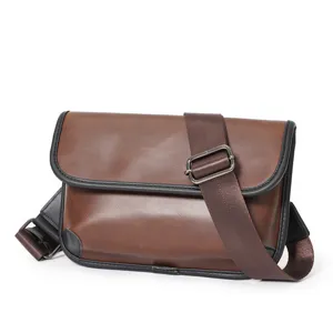 Detail view of the brown PU leather messenger bag with adjustable strap and metal hardware.