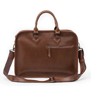 Close-up detail of the brown leather business briefcase with zipper pocket and shoulder strap.
