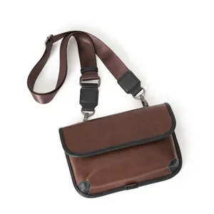 Detailed view of casual brown pu leather crossbody bag with black trim and adjustable strap.