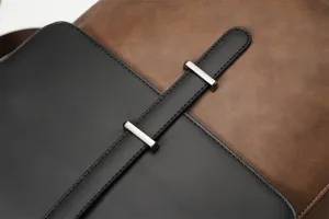 Detailed close-up of retro PU leather men backpack buckle and fine stitching texture.