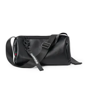 Black leather cylinder barrel shoulder bag featuring adjustable strap and chic tag.