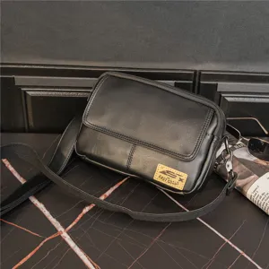 Detailed view of black leather crossbody bag with retro square messenger design for use.