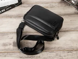 Detail view of black PU leather men sling bag, casual cross body shoulder bag with strap.