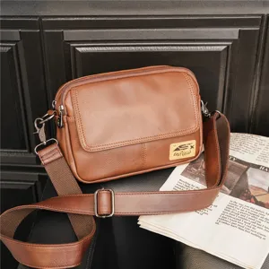 Brown vintage leather crossbody bag detail view, casual messenger bag with shoulder strap.