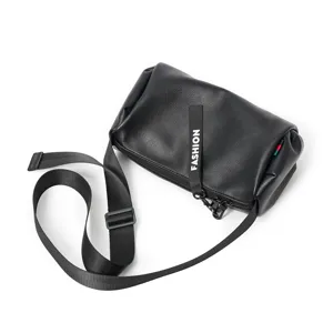 Black leather cylindrical crossbody bag detail, adjustable strap, daily casual style.